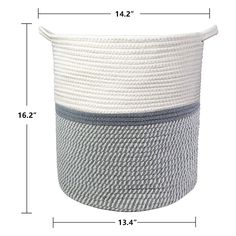 a large white and grey basket sitting on top of a table next to a ruler