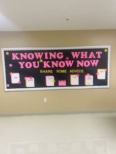 a bulletin board hanging on the wall in an office building that says, know what you know now share some advice