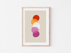 a framed art print with an abstract design in shades of pink, orange and white