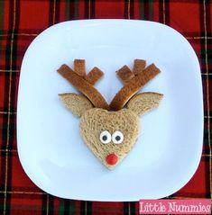 a white plate topped with a piece of bread covered in reindeer's antlers