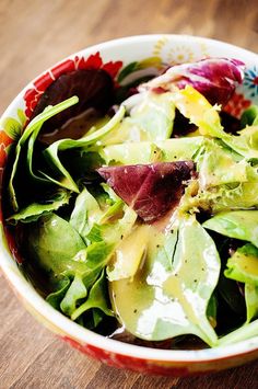 a close up of a salad in a bowl on a table