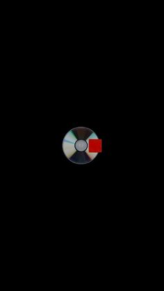 a black background with a red and white disc in the center on top of it