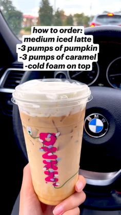 someone holding up a cup of coffee in their hand with the text how to order medium iced latte - 3 pumps of pumpkin 2 cups of caramel cold foam on top