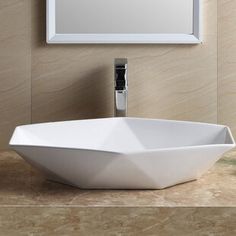 a white bowl sink sitting on top of a counter next to a mirror and faucet