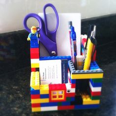 a lego desk organizer with scissors, pens and pencils