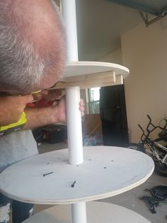 a man is working on a white table