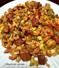 a white plate topped with rice and shrimp