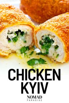 the chicken kyv is cut in half and served on a white plate with parsley