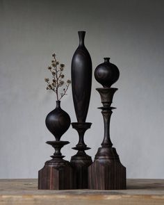 three wooden vases sitting on top of a table