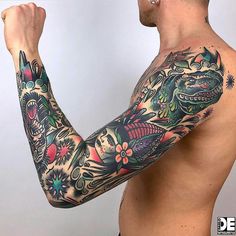 a man with a dragon tattoo on his arm and shoulder is flexing his muscles