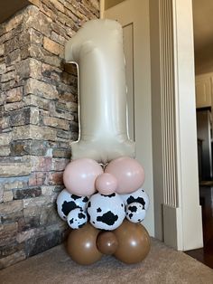 some balloons that are in the shape of animals and pandas on top of each other