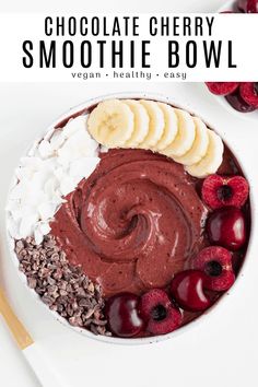 chocolate cherry smoothie bowl with bananas, cherries and whipped cream in the middle