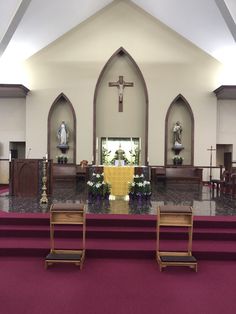 the inside of a church with pews and flowers