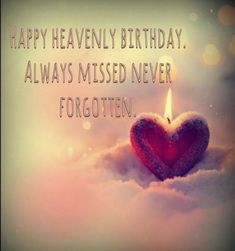 a heart - shaped candle is in the snow with words on it that say, happy heavenly birthday always missed never forgotten