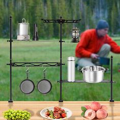 an outdoor cooking station with pots, pans and utensils on the table