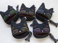 four zippered purses with cats on them