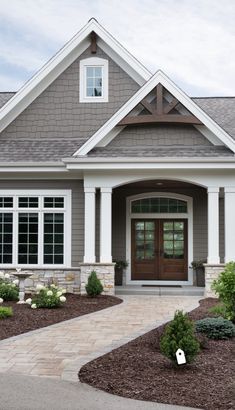 a house with landscaping around the front door