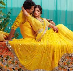 a man and woman dressed in yellow posing for a photo