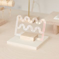 a wooden table topped with white and pink items