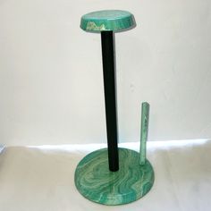 a green marble pedestal with a black base