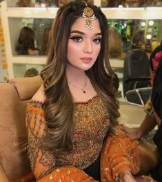 a woman sitting in a chair with long hair