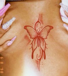 a woman's stomach with a butterfly tattoo on it