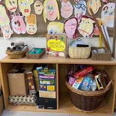 a child's play area with toys, books and crafts on the shelf in front of it