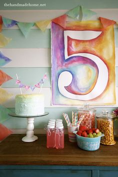 a table topped with a cake covered in frosting