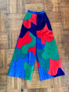 "1970's Mountain Artisans patchwork pants. Sold at the Jean Allen shop in Southport, Connecticut. This pants are amazing and are probably one of a kind There is interesting info on line regarding the Mountain Artisans....check it out!! High rise, wide legged pants are made of three different fabrics; red, blue, kelly and olive green corduroy, blue chenille and red cotton knit. Patches are organic shaped and are sewn together with a zig zag stitch in blue thread. Fully lined in a pale blue nylon. 1 1/2\" waistband, 8 3/4\" nylon zipper and metal hook and eye. Size 10. Excellent condition. all measurements are taken flat waist 25\" hips 36\" rise   front 15\"   back 15 1/2\" inseam 29\" length 42 1/2\" hem 15\"" Black Velvet Bodysuit, Funky Pants, Zig Zag Stitch, Wide Legged Pants, Patchwork Pants, Bow Scarf, Gogo Boots, Green Corduroy, Grandpa Sweater