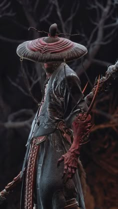 a statue of a man dressed as a demon holding a stick and wearing a hat