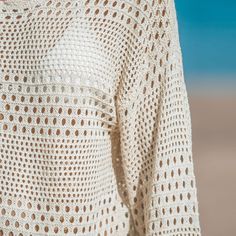 Wrap yourself in beachside bliss with our Seaside Whispers Crocheted Cover-Up. The delicate crochet detailing adds a touch of elegance and femininity to this cover-up. With its long sleeves, it's perfect for breezy days by the water, providing just the right amount of coverage while still allowing you to enjoy the beach or poolside atmosphere. The crochet design adds a beautiful texture and visual interest to the cover-up, creating a stylish and bohemian look. Whether you're lounging on the sand Bohemian Open Knit Poolside Cover-up, Bohemian Open Knit Cover-up For Poolside, White Open Knit Crochet Dress For Beach, White Open Knit Crochet Dress For The Beach, White Crochet Dress For Poolside In Spring, White Crochet Dress For Poolside Spring Occasion, White Crochet Dress For Poolside Spring Events, Bohemian White Beach Dress With Open Knit, Bohemian White Open Knit Beach Dress