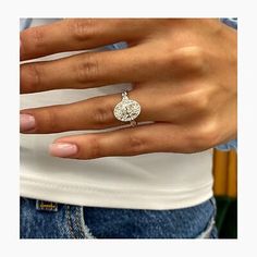 a woman's hand with a diamond ring on it