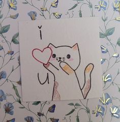 a card with a drawing of a cat holding a heart on it's back