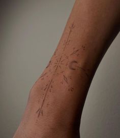 a person's arm with a tattoo on it that has arrows pointing to the sky