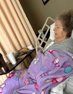 an older woman laying in a hospital bed