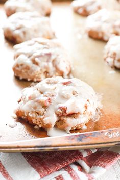 cookies with white icing on a baking sheet