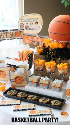 a basketball themed birthday party with orange and black decorations, cupcakes and snacks