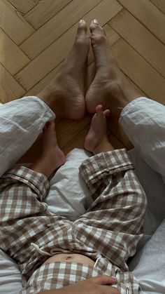 a person laying in bed with their legs crossed