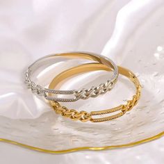 LOVCIA 18K Gold Plated Stainless Steel Radiant Chain Link Bangle Bracelet for Women Elevate your style with the LOVCIA 18K Gold Plated Stainless Steel Radiant Chain Link Bangle Bracelet for Women, a stunning piece of jewelry that embodies elegance and sophistication. Available in both an 18K gold-plated variant and a sleek silver variant, this bangle bracelet is crafted from high-quality stainless steel to ensure durability and long-lasting shine. Whether you choose the gold-plated or silver var Tarnish Resistant Bangle Chain Bracelet For Party, Silver Gold-plated Bangle Chain Bracelet, Gold Plated Silver Bangle Chain Bracelet, Silver Bracelets With Gold Chain For Wedding, Gold Curb Chain Bangle Bracelet, Cz Bracelet, Timeless Accessories, Christmas Jewelry, Stylish Jewelry