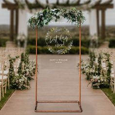 an outdoor ceremony with chairs and greenery