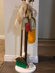 a broom and brush are hanging on the wall