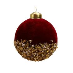 a red ornament with gold glitters on it