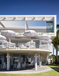 an outdoor dining area with umbrellas and chairs