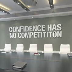 a conference room with white chairs and a large sign on the wall that says,'confidence has no competition '