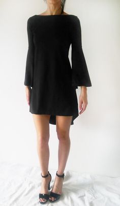 "Description: This minimalist black dress/tunic has wider sleeves and slight A-line body shape. The front bottom part of the dress is cut straight, and the back bottom part is longer and oval, so it gives it asymmetrical shape. It is tailored to fit loosely and fits all types of figures. Perfect for various occasions. Sizes: XS, S, M, L, XL, XXL & 3XL Care: turn the garment inside out for better washing results, machine wash cold, tumble dry low, warm iron if needed Fabric: elastic cotton je Black A-line Asymmetrical Dress For Formal Occasions, Black Stretch Asymmetrical Dress For Spring, Chic Black Stretch Asymmetrical Dress, Black Stretch Asymmetrical Dress For Date Night, Fall Mini Dress For Workwear With Asymmetrical Hem, Elegant Solid Color High-low Hem Dress, Modern Black Asymmetrical Evening Dress, Sleek Asymmetrical Hem Dress For Night Out, Elegant Black Asymmetrical Dress For Fall