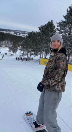 a young person on a snowboard in the snow