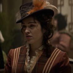 a woman wearing a hat with feathers on it's head in a scene from the tv show downton house