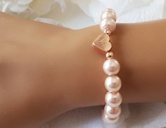 This personalized flower girl bracelet is made with blush pink color little glass pearls (8 mm) and rose gold plated hand stamped heart charm. This stretch pearl bracelet is perfect gift for your flower girls, jr bridesmaids or bridesmaids. Please visit my store to see the other wedding jewelry https://www.etsy.com/shop/asteriasbridal Adjustable Beaded Bracelets With Heart Charm For Wedding, Adjustable Pearl Bracelet For Wedding On Valentine's Day, Personalized Rose Gold Bracelets For Wedding, Elegant Beaded Bracelet With Heart Charm For Wedding, Elegant Wedding Beaded Bracelet With Heart Charm, Personalized Rose Gold Wedding Bracelets, Elegant Personalized Rose Gold Beaded Bracelets, Elegant Personalized Rose Gold Beaded Bracelet, Adjustable Rose Gold Heart Bracelet For Wedding