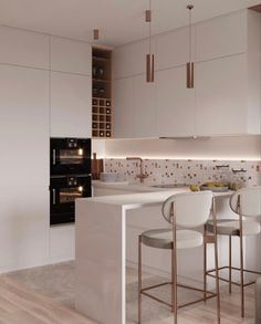 a modern kitchen with white cabinets and gold accents