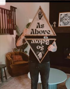 a man holding up a sign that says as above